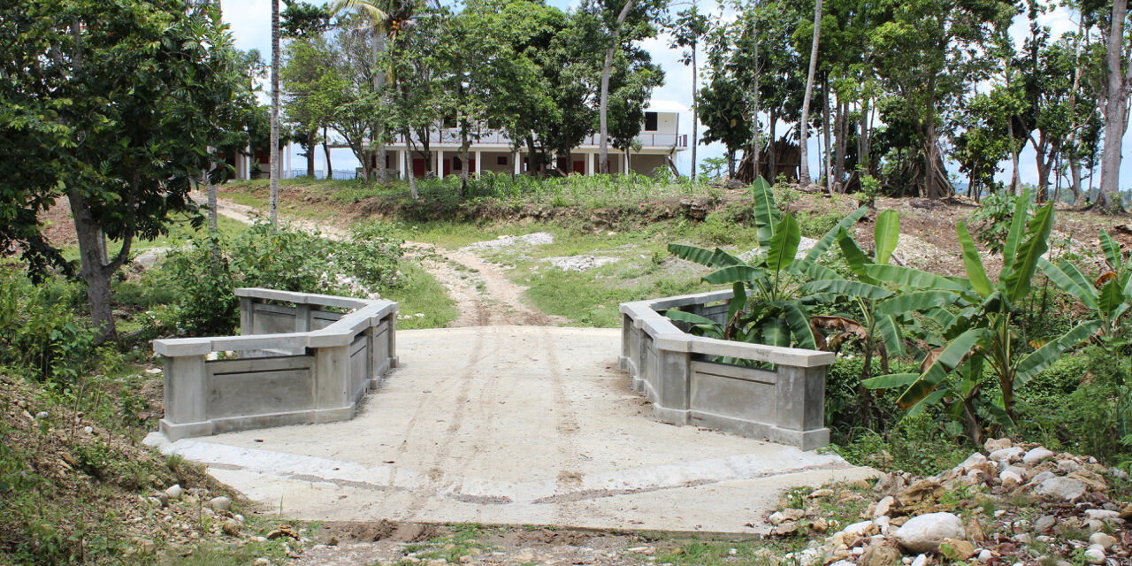 Completion of bridge over the creek.